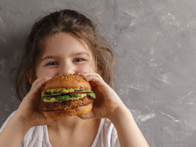 Child eating a veggie burger